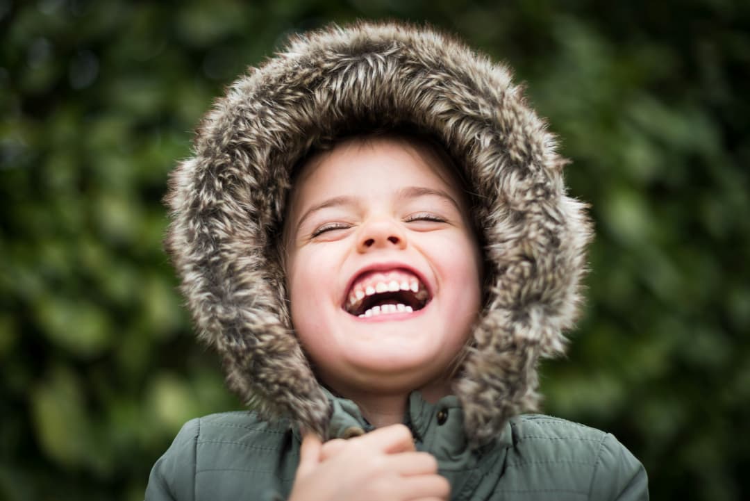Child laughing with eyes closed in a candid moment